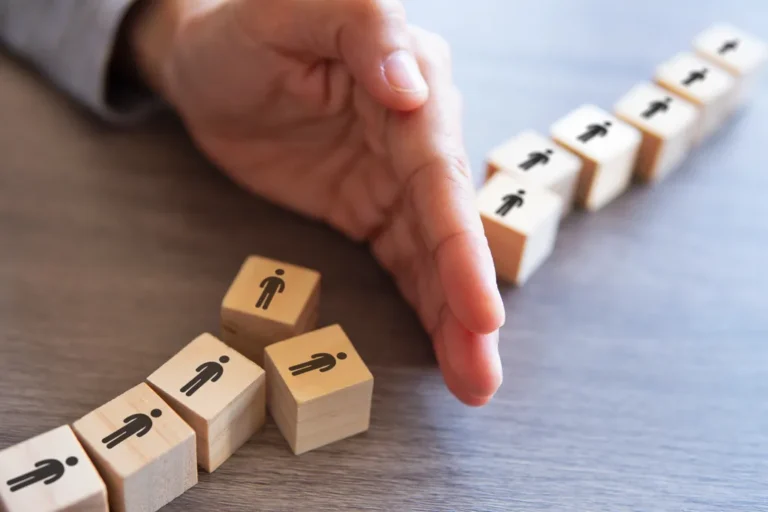 Hand separating group of people layoff concept